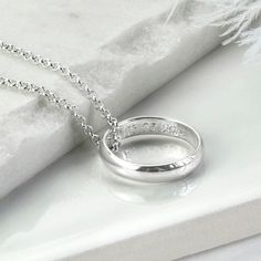 "Our beautiful Sterling Silver Secret Message Ring Necklace is the perfect way to give someone special a stunning necklace complete with a secret message they can carry with them everywhere. The necklace is available with either a luxurious polished finish or hammered finished ring. We can engrave the inside of these rings with your secret message. The ring comes one a fine belcher chain, available in five different lengths. So why not make this a truly personal gift by having your own special message engraved, by us To order this necklace simply select the chain length and the font you would like us to use from the drop down menus, you can select \"no engraving\" if you would like us to leave it blank. Then at the checkout, let us know which finish you would like, either polished or hamme Wedding Ring Necklaces, Special A, Square Rings, Engraved Items, Stunning Necklace, Sterling Silver Necklace, Cute Jewelry, Ring Necklace, Handmade Ring