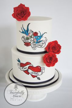 a three tiered white cake with red roses on the top and black trimmings