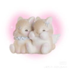 two stuffed animals sitting next to each other on a white surface with pink and blue lights in the background