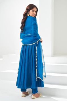 Blue pleated flare anarkali, highlighted with placement pita and kasab work. Paired with a pant and scallop trimmed dupatta.
Components: 3
Pattern: Placement Embroidery
Type Of Work: Pita, Kasab
Neckline: V Neck
Sleeve Type: Full Sleeves
Fabric: Soft Chanderi, Lining: Chanderi
Color: Blue
Other Details: 
Attached inner lining
Length:
Anarkali: 52 inches
Sleeves: 23 inches
Pant: 38 inches
Dupatta: 2.5 mtrs
Occasion: Mehendi and Haldi - Aza Fashions V Neck Anarkali, Placement Embroidery, Types Of Work, Blue Soft, Full Sleeves, Pant Set, Set For Women, Anarkali, Aza Fashion