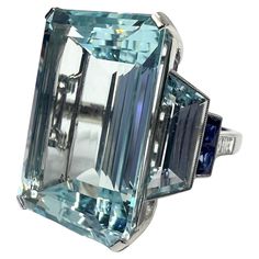 Platinum ring with 24.12 carat aquamarine, 0.27 carat diamond , 0.24 carat sapphire and 0.27 carat aquamarine. Sophia D by Joseph Dardashti LTD has been known worldwide for 35 years and are inspired by classic Art Deco design that merges with modern manufacturing techniques. Formal Light Blue Diamond Ring, Luxury Gia Certified Aquamarine Ring, Luxury Aquamarine Octagon Ring, Luxury Octagon Aquamarine Ring, Aquamarine Brilliant Cut Diamond Ring For Formal Occasions, Formal Aquamarine Diamond Ring With Brilliant Cut, Formal Light Blue Aquamarine Diamond Ring, Formal Light Blue Diamond Ring With Center Stone, Formal Light Blue Topaz Ring