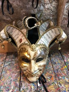 Original hand-painted Venetian mask embellished with gold leaf, decoration with stucco, acrylic colors and precious fabrics. -Material/Resin Made in Italy hypoallergenic and anatoxical -Dimensions/40x37Unisex -History of the mask / the Jester or joker is a mask that appears in Venice in 1970 year in which the Venetian Carnival returns to its former glory after being interrupted during the Napoleonic domination (1700') and Austro-Hungarian (1800'). Formerly a symbol of transgression and enjoyable Venetian Jester, Jester Mask, Joker Mask, The Jester, Venice Mask, Venetian Carnival, Carnival Mask, Leaf Decoration, Joker Is