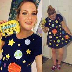 a woman in a space themed dress holding a cell phone