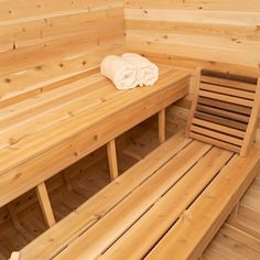 a sauna with wooden benches and towels on it