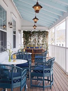 an outdoor dining area with blue chairs and tables