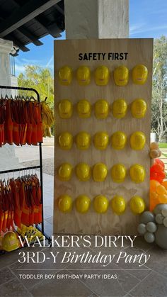 a birthday party sign with oranges and yellow candies in front of it that says walker's dirty birdy birthday party