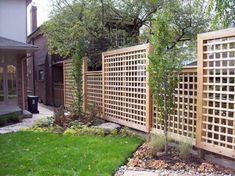 a wooden fence in the middle of a yard