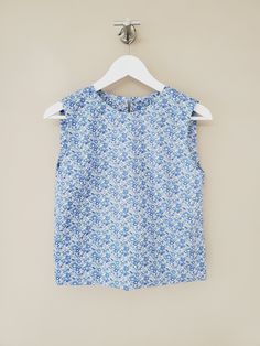 "Liberty sleeveless top / Cropped hem cotton blouse. Handmade by littleflowerfabric / Liberty Tana Lawn Top / Silk -like touch / Pullover STYLE * Fits neatly across the shoulders. * Gentle, shape that floats subtly away from the body. * No zipper, pullover. * Right above bust including armhole up to neckline is lined with the same fabric as blouse for fit. DETAILS * Made with Liberty Tana Lawn. Cotton 100%. Lightweight. Very soft. From the world famous Liberty Fabrics with a silk-like touch, unique print quality and striking color vibrancy. PLEASE NOTE * Made to order. Hand made. Neither returnable nor exchangeable. * All garments are approximate as to be expected with the handmade. PLEASE CHECK * The measurements carefully. (Especially the body BUST measurements) The most important thing Printed Sleeveless Spring Tops, Printed Sleeveless Tops For Spring, Printed Cotton Sleeveless Tank Top, Fitted Sleeveless Printed Blouse, Cotton Ruffle Tank Top, Printed Sleeveless Cotton Blouse, Printed Cotton Sleeveless Blouse, Blue Floral Print Sleeveless Top, Blue Sleeveless Floral Print Top