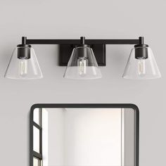 a bathroom vanity with two lights and a mirror