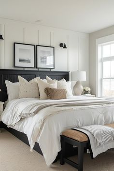 a bed with white linens and pillows in a bedroom next to a large window