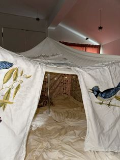 a white tent with blue birds painted on it