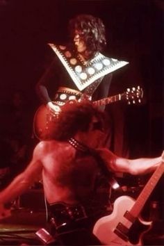 an image of a man that is playing guitar and wearing a bandleader's outfit