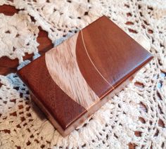 a wooden box sitting on top of a doily