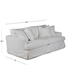 a white couch with pillows on it and measurements