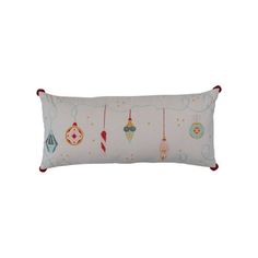 a white pillow with christmas ornaments hanging from it's sides on a white background