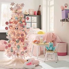 a white christmas tree with candy canes and candies on it's branches