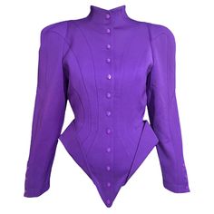 Futuristic Thierry Mugler vibrant purple jacket from the Fall Winter 1988 "Les Infernales” collection and variations of it were seen on the runway. This rare jacket features a structured corseted waist with upturned peplum hips. Contoured seam detailing throughout. Snap button front. Condition: Excellent condition, no size or material tags present. Measurements: Shoulder- 36” Bust- 34” Waist- 26” Length- 27” Mugler Corset, Corset Jacket, Stage Clothes, A Fashion Designer, Purple Jacket, Thierry Mugler, Vibrant Purple, Ely, Winter Coat