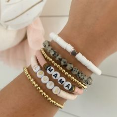 "Brand new to the Louis and Finn, our heishi beads have quickly become an arm party must have! So cute! So fun! Personalize with your wording and pick your favorite color from the drop down menu. Pick from our beautiful pale peachy pink heishi, leopard stones, dainty 4 mm gold beads, white heishi and brand new to the shop -- mauve heishi! We have now added the option to shop this EXACT look! If you select \"set of 6 bracelets\" from the dropdown menus, the bracelets will come as displayed (2 gol Custom Name White Heishi Beads Bracelets, Bohemian Heishi Letter Beads, Personalized White Heishi Beads Bracelet, White Name Bracelet With Letter Beads And Heishi Beads, Gold Heishi Beads Name Bracelet As Gift, Disc Bracelet, Boho Girl, Rose Gold Heart, Arm Party