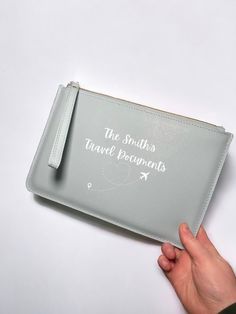 a person holding a travel document case with the words, the smiths travel documents