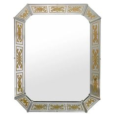 a mirror with gold and white designs on it