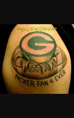 a green bay packers fan has tattoos on his arm and shoulder that reads,'i am the packers super fan 4 ever '