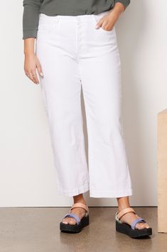 A bright white wash updates this stylish wide leg jean by Paige. Crafted in soft cotton denim with a hint of stretch, this high-rise silhouette features an exposed button fly and ankle-length hems—perfect for showing off your shoe game. 98% Cotton, 2% Elastane Denim White Mid-rise Wide Leg Denim Pants, White High Rise Denim Wide Leg Pants, White High-rise Wide Leg Denim Pants, White Cropped Wide Leg Cotton Pants, White Cotton Cropped Jeans For Work, Trendy White Denim Wide Leg Pants, White Wide-leg Denim Jeans, White Wide Leg Jeans With Frayed Hem, Chic White High Rise Cropped Jeans