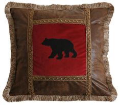 a brown and red pillow with a black bear on it