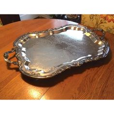 a silver tray sitting on top of a wooden table