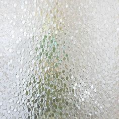 a vase filled with flowers sitting on top of a window sill covered in frosting