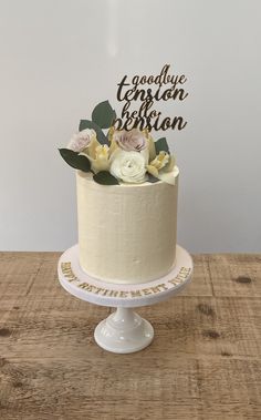 a white cake with flowers and the words goodbye houston on top is sitting on a wooden table