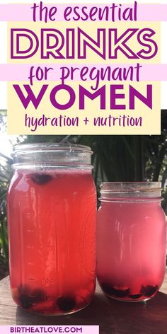 two jars filled with pink liquid sitting on top of a wooden table