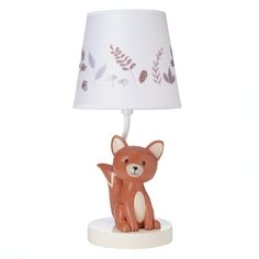 a small lamp with a little fox on it's base and a white shade