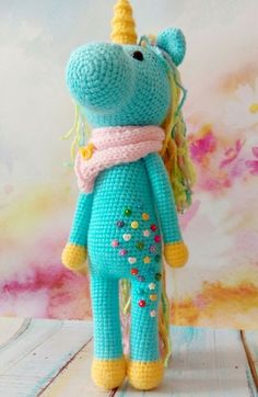 a crocheted stuffed animal with a scarf around it's neck