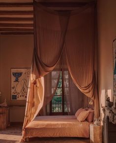 a bedroom with a canopy bed in the middle of it's walls and windows