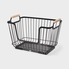 a black wire basket with wooden handles