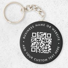 a black keychain with a qr code printed on the front and back