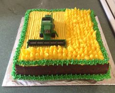 a cake that has been decorated to look like a farm scene with a tractor on it