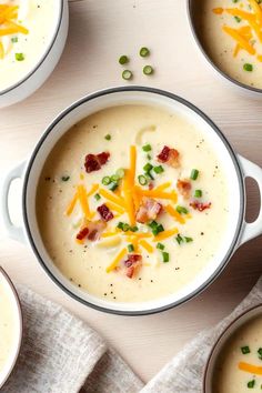 four bowls filled with soup on top of a table