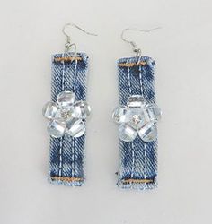 pair of earrings made out of jeans with crystal stones