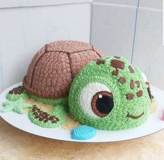 a cake made to look like a turtle and a turtle shell on a white plate