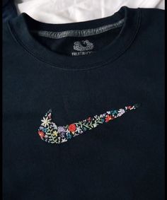 a t - shirt with a flowered nike logo on it