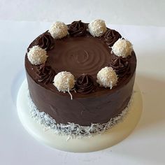 a chocolate cake with white and brown decorations