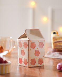 a small cake box sitting on top of a wooden table