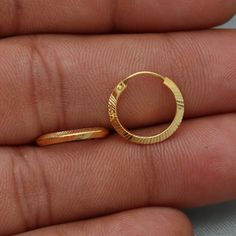 20kt 20 karat small hoop cartilage yellow gold Hoop Bali earrings  Gold Purity- 20k yellow Gold Weight - 0.98 grams approx Full Length - 1.3 cm approx Full Width - 1.3 cm approx click to see similar  https://www.etsy.com/in-en/shop/morvijewels?ref=seller-platform-mcnav Click here  https://morvijewels.etsy.com/    to get more discount and offers Happy to take wholesale bulk orders. Gold-plated Round Cartilage Earrings, Hallmarked Hoop Huggie Earrings For Gift, Elegant Hoop Nose Rings Gift, Gift Hallmarked Hoop Huggie Earrings, Small Hoop Gold Plated Rings As Gift, Gold Hallmarked Huggie Earrings For Gifts, Gold Plated Yellow Gold Hoop Cartilage Earrings, Gold Plated Small Hoop Rings As Gift, Gold Plated Hallmarked Hoop Earrings As Gift