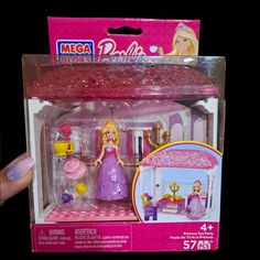 a barbie doll plays with her castle set