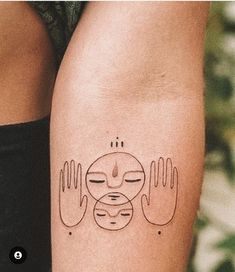 two hands with faces on each side of the arm