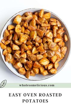 roasted potatoes in a white bowl with the words easy oven roasted potatoes