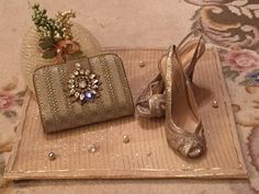 a pair of shoes and purse sitting on top of a rug