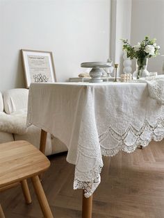 the table is covered with white linens and lace