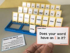 a person holding up a card with words on it next to a blue and yellow keyboard